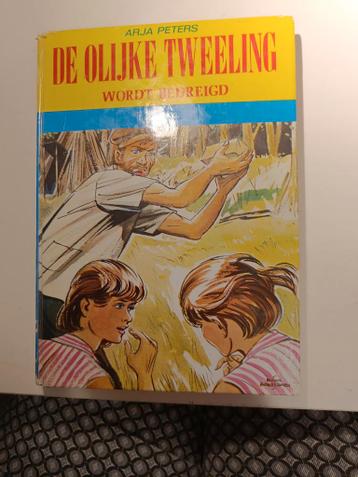 De Olijke Tweeling Wordt Bedreigd - Arja Peters