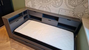 Eenpersoonsbed met matras, hokjes en kasten