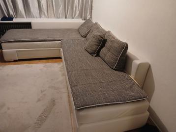 Grijze hoekbank/slaapbank met kleine mankementen