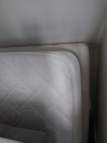 Twee matrassen en een volledig houten bed.