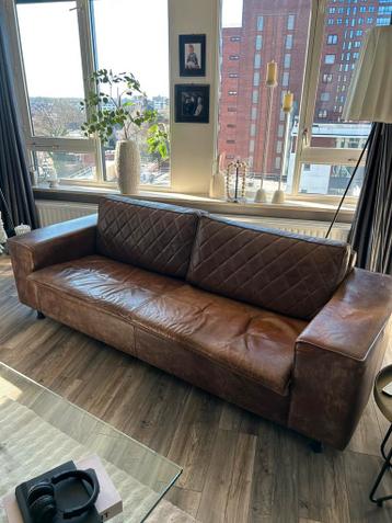 Leuke bank bruin leer ziet er redelijk goed uit