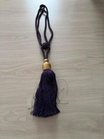 Paarse gordijnkwast met gouden accent