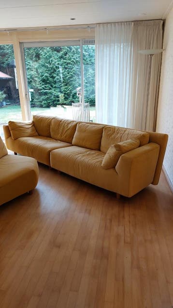 Gele hoekbank met losse fauteuil