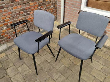 Twee grijze stoelen met armleuningen