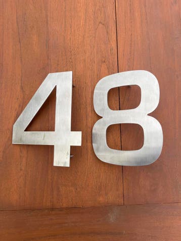 Huisnummers 4 en 8 van geborsteld metaal