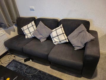 Donkergrijze stoffen bank met losse chaise longue