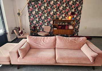 Roze bank met poef voor een bos bloemen