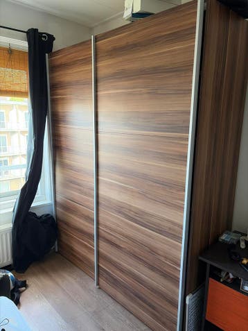 Ruime kledingkast met schuifdeuren en planken