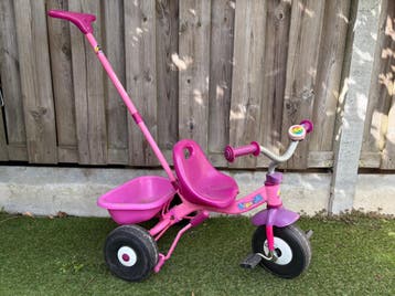Roze driewieler met duwstok