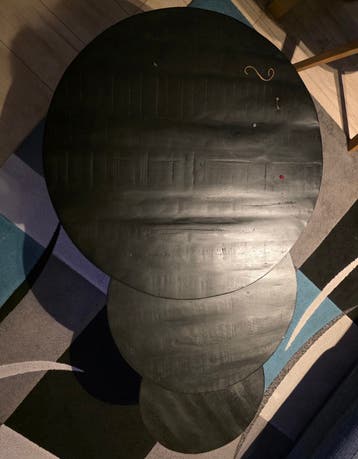 Set of three black, round side tables