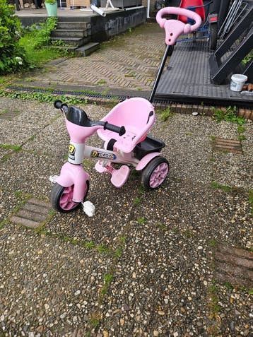 Roze kinder driewieler met duwstang