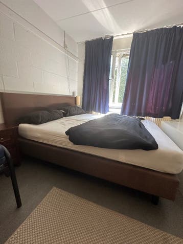 Bed with mattress and nightstand