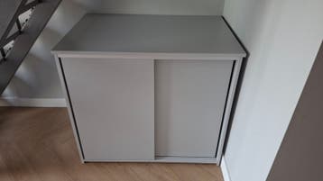 Grijze kast met schuifdeuren en uitsparing achterkant