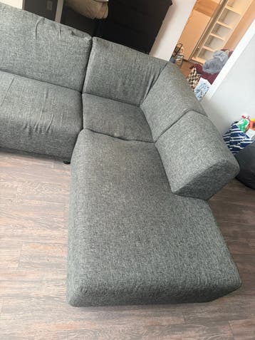 Grijze stoffen hoekbank met chaise longue
