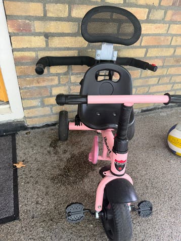 Roze driewieler en verstelbare zitting