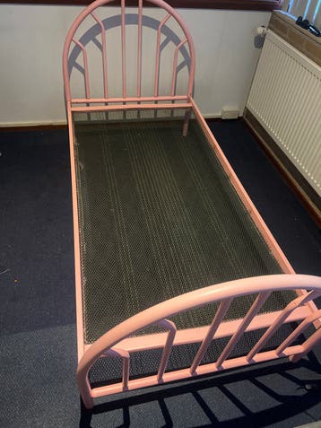 Roze eenpersoonsbed met metalen frame